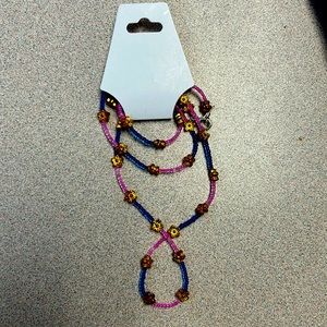 27 1/2 pink and purple dead beaded belly chain with gold flower spacers